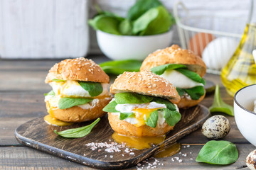 Veggie burger with poached egg and sorrel in a curd bun on rice flour