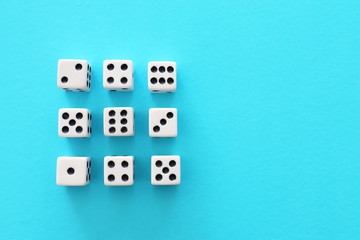 Rolling Dices over blue background. Casino gambling concept