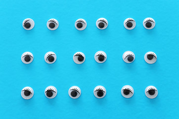 many googly eyes over blue background