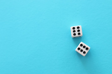 Rolling Dices over blue background. Casino gambling concept