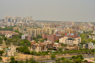 Fototapeta na wymiar Aerial shot Cityscape in Gurgaon, Noida, Jaipur, Delhi, Lucknow, Mumbai, Bangalore, Hyderabad showing small houses, sky scrapers and other infrastructure of the business district in the urban areas. 