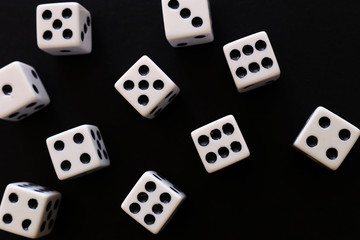 Rolling Dices over black background. Casino gambling concept