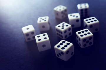 Rolling Dices over black background. Casino gambling concept