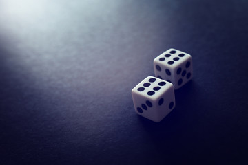 Rolling Dices over black background. Casino gambling concept