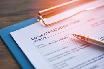 Loan application form with pen on paper / financial loan negotiation for lender and borrower - obrazy, fototapety, plakaty