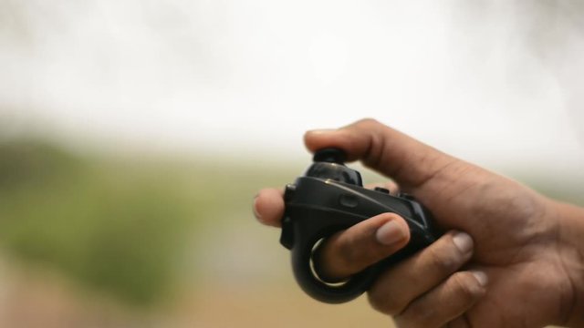 Closeup of hand operating the VR headset Bluetooth controller.