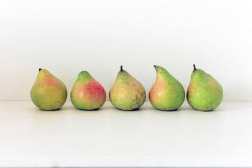 Fresh ripe pears on white background, vegetarian concept.