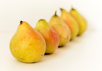 Fresh ripe pears on white background, vegetarian concept.
