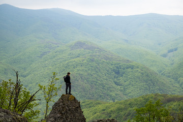 Boy standing on a cliff