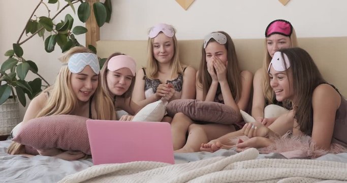 Girls laughing out loud while watching media content on laptop