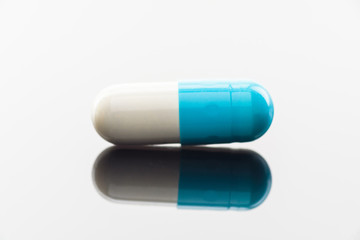 Capsule with medicine photographed close up.
