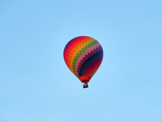 Colorful hot-air balloon in front of a clear blue sky