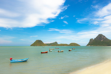 Sea water with fishing boats and blue skies is a beautiful natural summer travel concept.