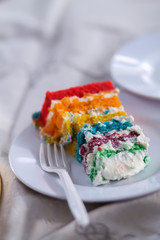 Colorful cake slice on white table.