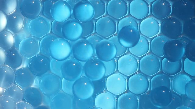 Water blue gel balls. Polymer gel. Silica gel. Balls of blue hydrogel. Crystal liquid ball with reflection. Texture background. Close up macro