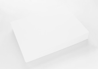 A4 blank paper stack with soft shadows isolated on white background