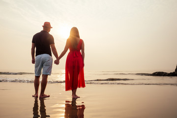 Young couple in love on the beach February 14, St. Valentine's Day sunset Goa India vacation trip...