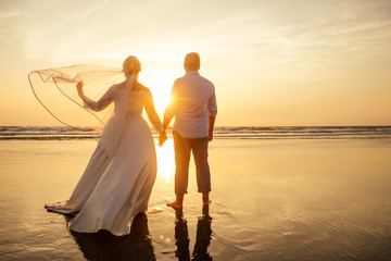 Fototapeta premium Young couple in love on the beach February 14, St. Valentine's Day sunset Goa India vacation trip .travel new year in a tropical country. freedom concept