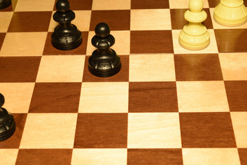 Chechered board under white chessmen like a sport backdrop
