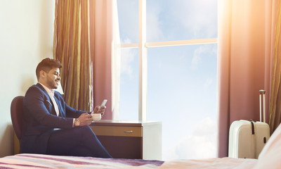 Business Trip. Businessman Using Phone And Drinking Coffee