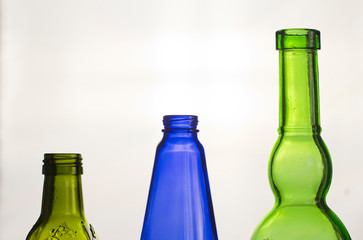green bottles of beer isolated on white background.  bottles on a white background. bottles of multicolored glass. alcoholic beverages. bottle neck background