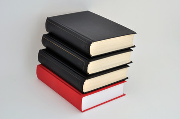 A stack of books on a light background with a field for writing text or inscriptions
