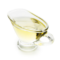 Olive oil in glass jar on white