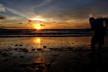 the beauty of Jimbaran beach in Bali Indonesia at dusk with the sun disappearing