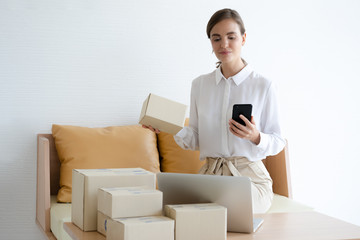 freelance woman working with box at home, small business owner online marketing packaging box and delivery, SME concept
