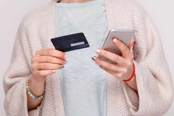 Woman's hand with credit card and phone isolated