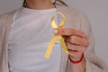 Yellow ribbon in the hand. Sarcoma concept