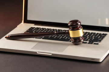 Closeup view of judje gavel on a laptop