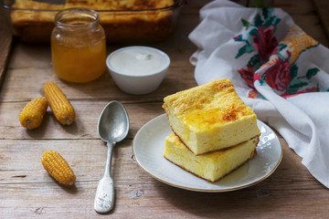 Traditional Romanian or Moldavian cottage cheese casserole with cornmeal, served with honey and sour cream.