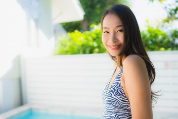 Fototapeta na wymiar Portrait beautiful young asian woman smile happy relax around swimming pool in hotel resort for leisure