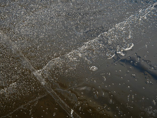 Cracks in ice piece or drifting floe board. Ice create many reflections and flares thanks light refractions.