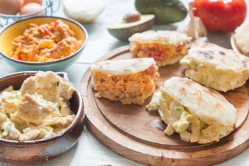 Arepas with reina pepiada and egg revueltos