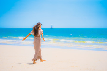 Portrait beautiful young asian woman smile happy walk on the tropical outdoor nature beach sea