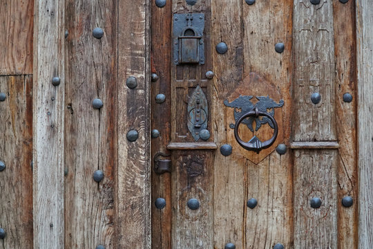 Vintage metal Handle on the old wooden door, closeup