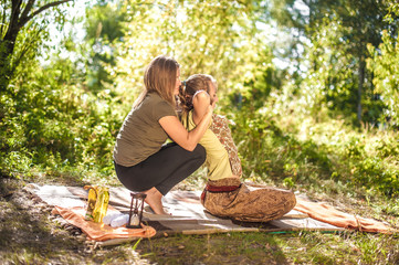 Massage professional demonstrates refreshing massaging methods in a forest clearing.