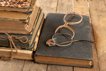 Broken frame from glasses. Old book and glasses.