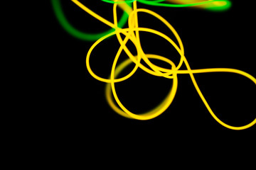 Fototapeta premium Yellow neon and green neon abstract. Neon lines. Isolated on black background.