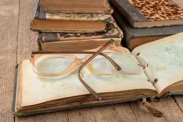 Broken frame from glasses. Old book and glasses.