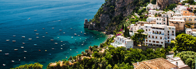 Picturesque panoramic image of Amalfi coast, hillside houses turquoise bay of Mediterranean Sea. Positano, Italy