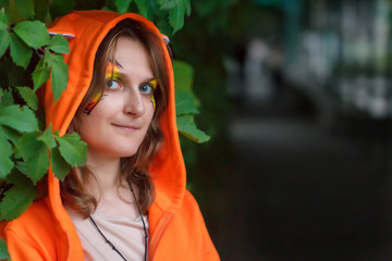 Unusually dressed woman with a slight madness in her eyes. A girl in a fantasy hero costume and the...