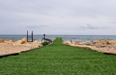 Green catwalk entering the mediterranean sea in Ayia Napa, East Cyprus. Ideal mole for best models...