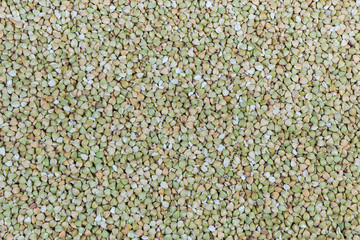 Background of uncooked not steamed buckwheat groats