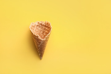 Crunchy wafer cone on color background