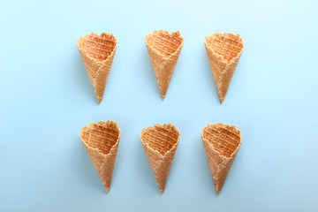 Crunchy wafer cones on color background