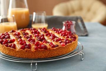 Tasty cranberry pie on table