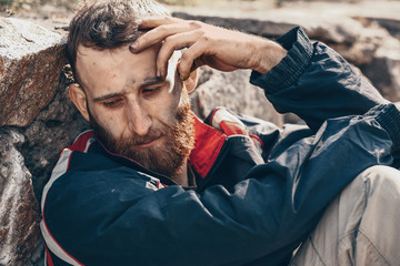 Portrait of sad homeless man outdoors